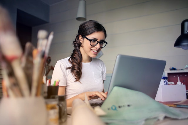 women at laptop happy